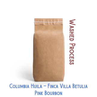 A brown bag containing pink bourbon coffee beans is pictured against a white background. The labels "Washed Process" and "Colombia Huila Finca Villa Betulia Pink Bourbon" are placed around the bag.